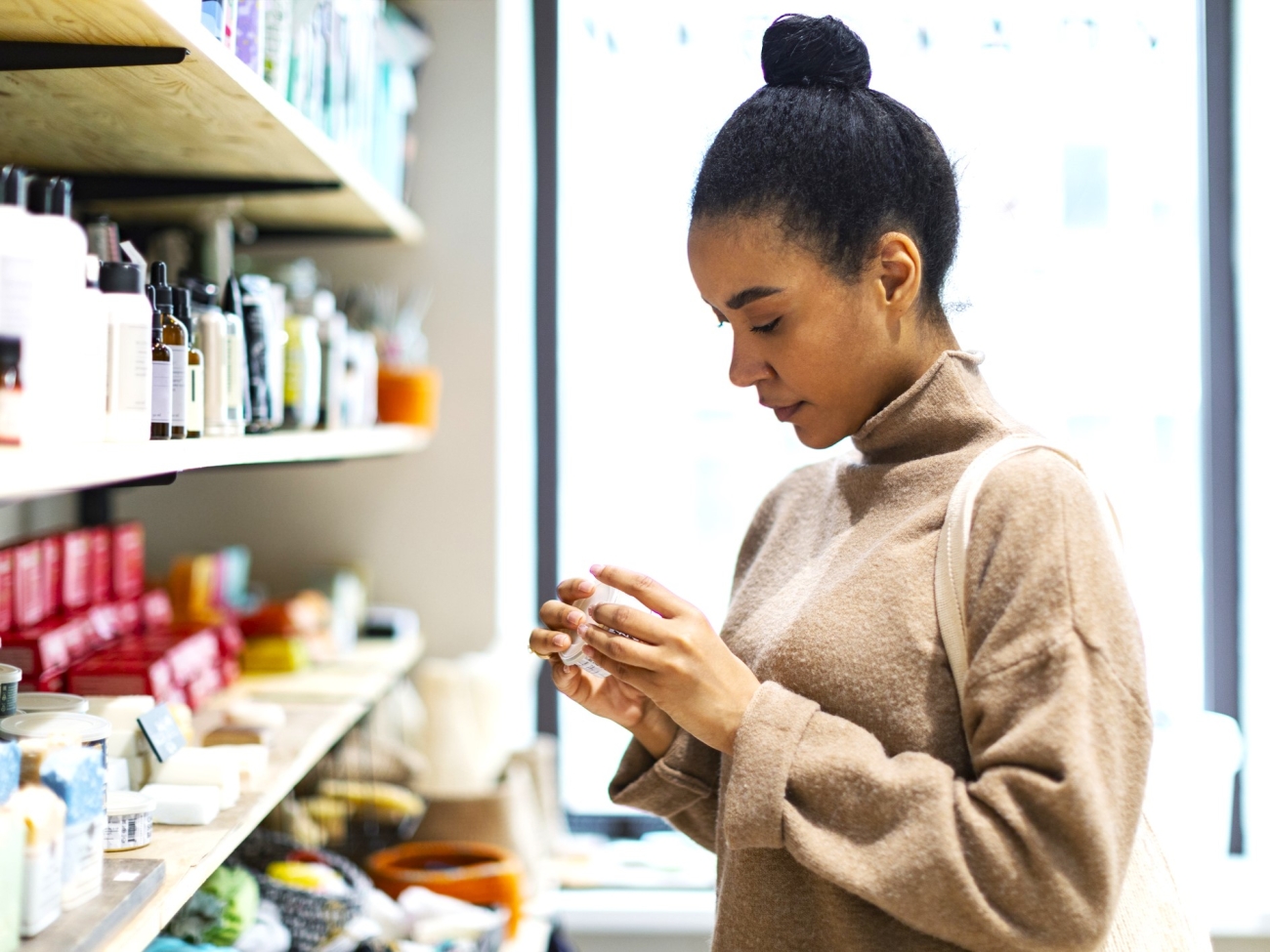 Black woman shopping for cosmetics