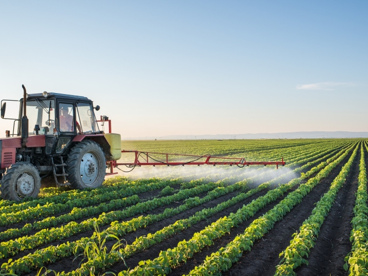 truck spraying crop with pesticides